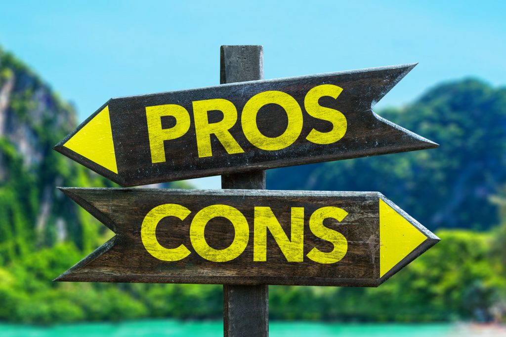 Pros Cons signpost in a beach background